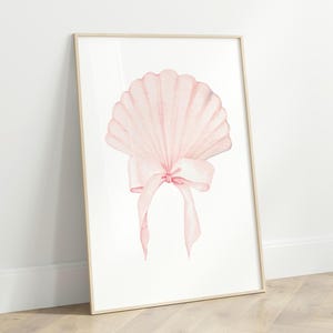 May include: A watercolour painting of a pink seashell with a pink bow. The seashell is in the centre of the image and is surrounded by a white background.