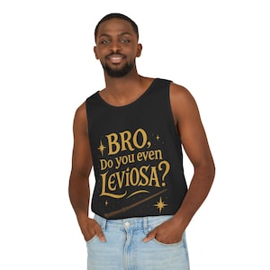 May include: Black vest top featuring the phrase "BRO, Do you even LEVIOSA?" in gold lettering, with a wand and stars design. The top is worn by a person in blue jeans.