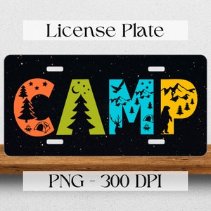 May include: A black license plate with the word "CAMP" in colorful letters. Each letter is decorated with camping-themed imagery, including trees, mountains, a tent, a campfire, a deer, a bear, a bird, and a crescent moon. The background is a black starry sky.