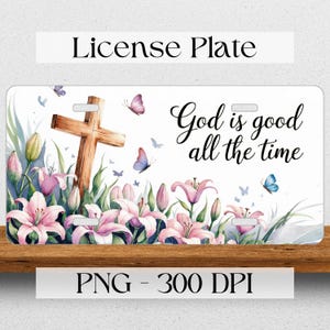 May include: White license plate with a wooden cross and pink lilies. The text "God is good all the time" is written in black cursive.