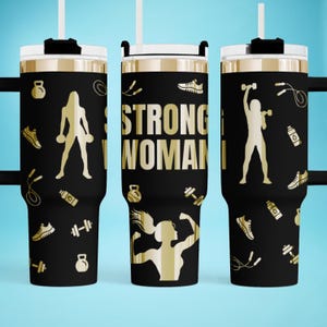 May include: Black tumbler with gold accents and a white lid. The tumbler features gold silhouettes of women exercising, dumbbells, sneakers, and the text "STRONG WOMAN". Includes a white straw and black handle.