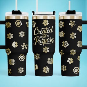 May include: A black stainless steel tumbler with a gold floral pattern and the text "Created with a Purpose".