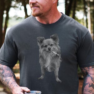 A pepper grey unisex Comfort Colors 1717 t-shirt featuring a grayscale image of a long hair Chihuahua standing with a cigarette in its mouth, giving a humorous, meme-style look perfect for dog lovers and fans of funny novelty shirts.