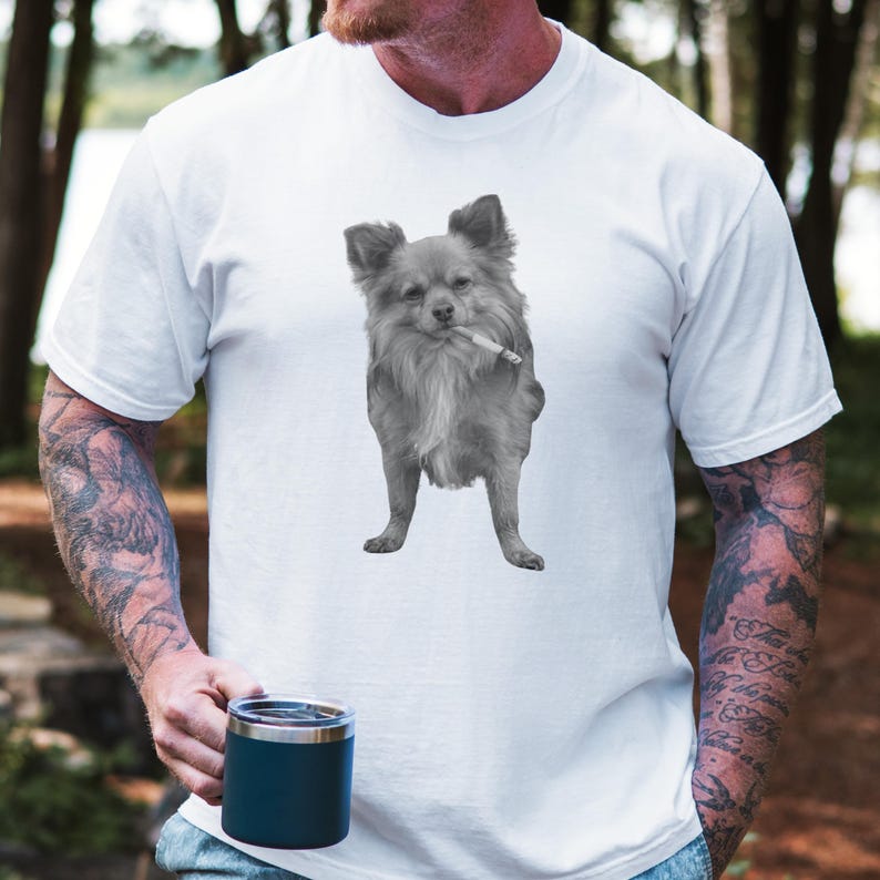 A white unisex Comfort Colors 1717 t-shirt featuring a grayscale image of a long hair Chihuahua standing with a cigarette in its mouth, giving a humorous, meme-style look perfect for dog lovers and fans of funny novelty shirts.
