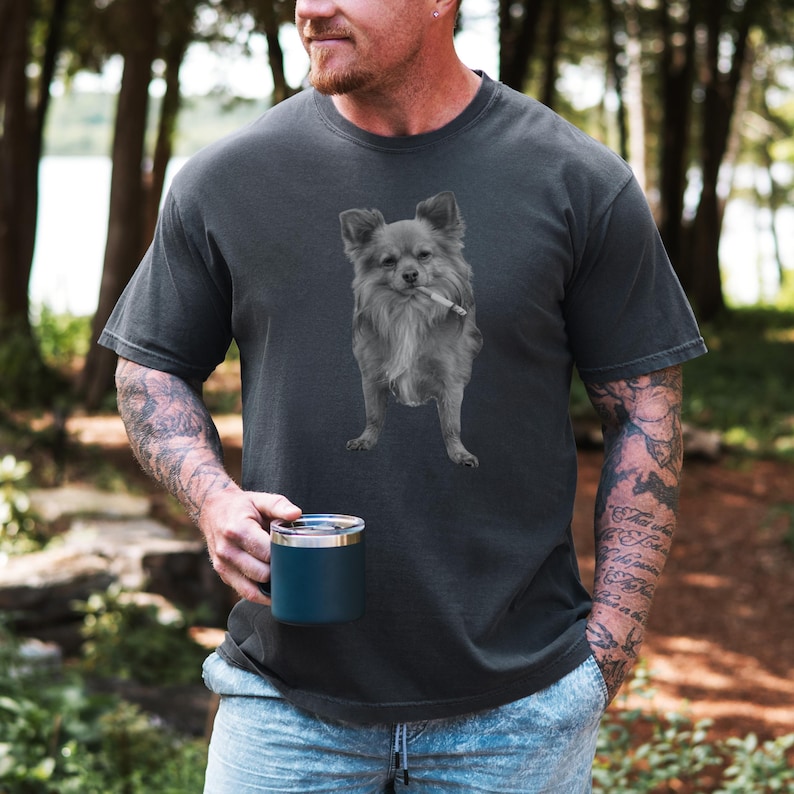 A pepper grey unisex Comfort Colors 1717 t-shirt featuring a grayscale image of a long hair Chihuahua standing with a cigarette in its mouth, giving a humorous, meme-style look perfect for dog lovers and fans of funny novelty shirts.