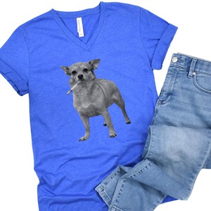 A royal blue unisex vee-neck t-shirt featuring a grayscale image of a Chihuahua standing with a cigarette in its mouth, giving a humorous, meme-style look perfect for dog lovers and fans of funny novelty shirts.