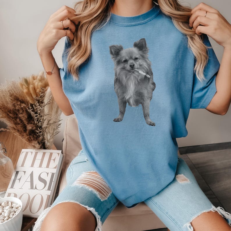 A blue-jean colored unisex Comfort Colors 1717 t-shirt featuring a grayscale image of a long hair Chihuahua standing with a cigarette in its mouth, giving a humorous, meme-style look perfect for dog lovers and fans of funny novelty shirts.