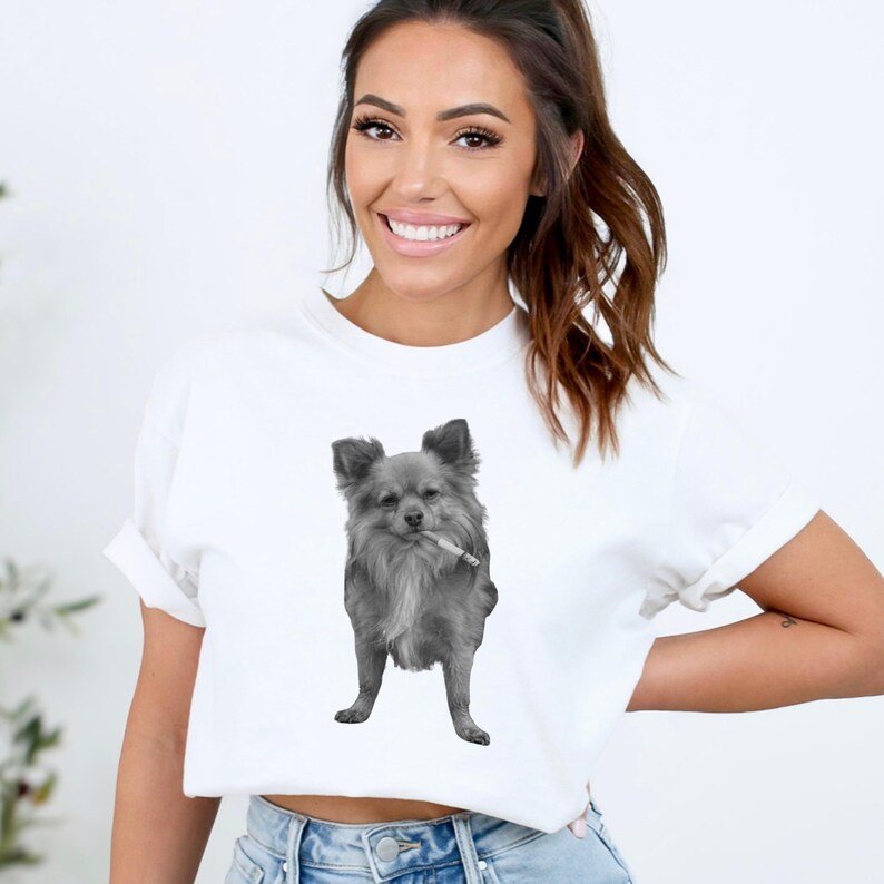 A white unisex Comfort Colors 1717 t-shirt featuring a grayscale image of a long hair Chihuahua standing with a cigarette in its mouth, giving a humorous, meme-style look perfect for dog lovers and fans of funny novelty shirts.