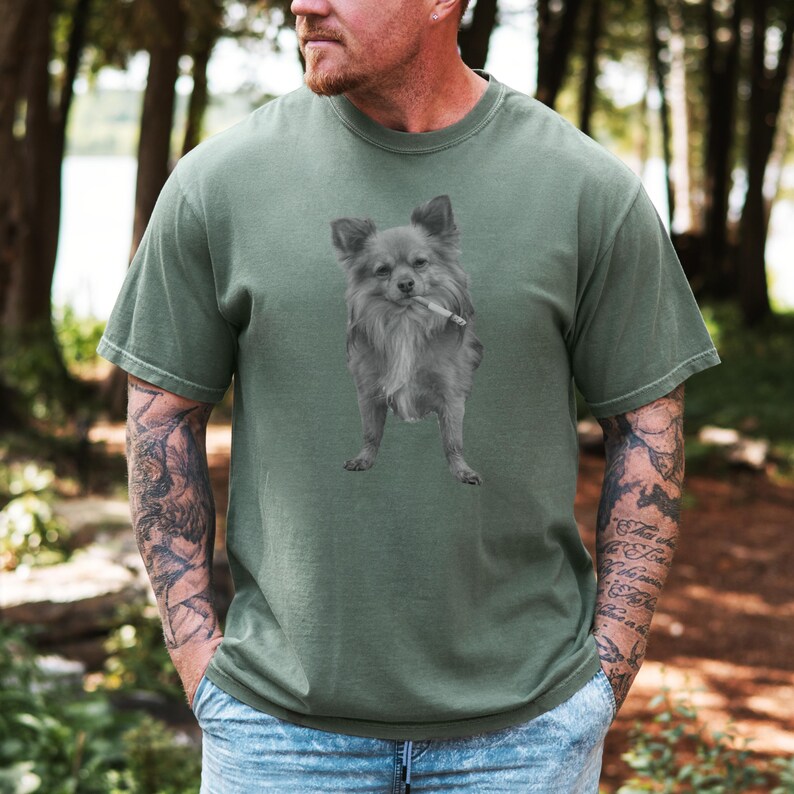 A moss green unisex Comfort Colors 1717 t-shirt featuring a grayscale image of a long hair Chihuahua standing with a cigarette in its mouth, giving a humorous, meme-style look perfect for dog lovers and fans of funny novelty shirts.