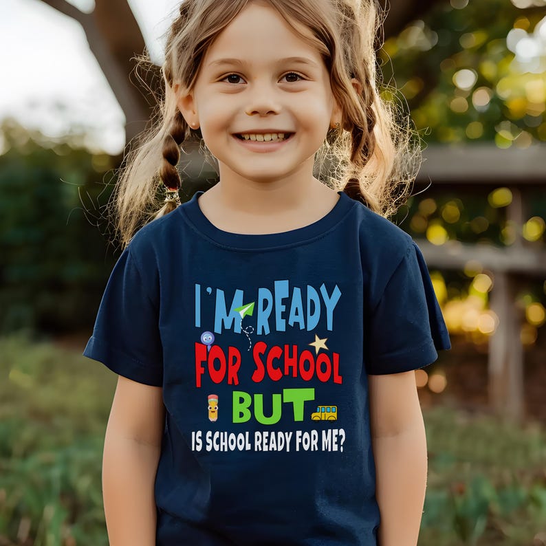navy blue kids crewneck t-shirt that reads “I’m ready for school but is school ready for me?” in colorful letters with fun icons.