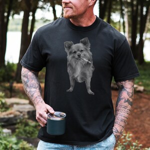 A black unisex Comfort Colors 1717 t-shirt featuring a grayscale image of a long hair Chihuahua standing with a cigarette in its mouth, giving a humorous, meme-style look perfect for dog lovers and fans of funny novelty shirts.