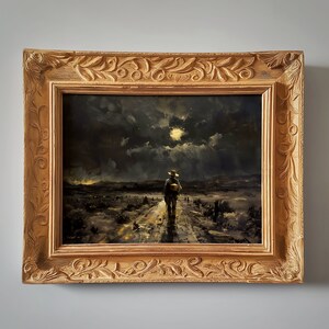 May include: A framed oil painting depicting a lone figure walking on a dirt road under a cloudy night sky with a full moon. The figure is wearing a hat and carrying a bag. The painting is set in a rustic landscape with a dark background.