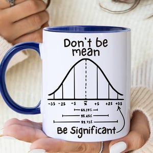 May include: White ceramic mug with a blue handle and rim. The mug features the text "Don't be mean, Be Significant" with a bell curve diagram. A perfect gift for a math or statistics enthusiast.