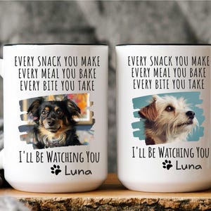 May include: Two white ceramic mugs with black handles. Each mug features a dog photo, the text "Every snack you make, every meal you bake, every bite you take, I'll be watching you", and the name "Luna".