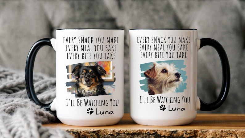 May include: Two white ceramic mugs with black handles. Each mug features a dog photo, the text "Every snack you make, every meal you bake, every bite you take, I'll be watching you", and the name "Luna".