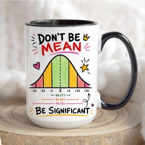 May include: A white ceramic mug with a black handle and interior rim. The front features a colorful bell curve graph with the text "DON'T BE MEAN" at the top and "BE SIGNIFICANT" at the bottom, including statistical markings and percentages.