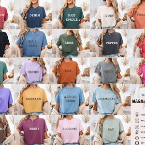 May include: A collection of short-sleeved t-shirts in various colors, each labeled with a color name in white text. Colors include Crimson, Denim, Blue Spruce, Ivory, Terracotta, Black, Blue Jean, Moss, Pepper, and Watermelon.