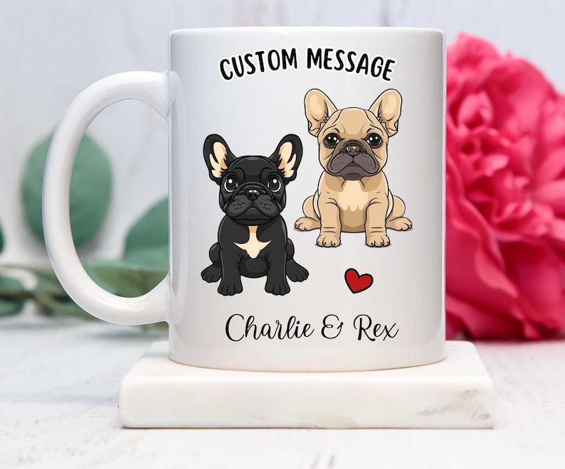 May include: White ceramic mug with a custom message that reads "CUSTOM MESSAGE" and features two cartoon French Bulldogs. The dogs are named Charlie and Rex. A red heart is between the dogs' names.