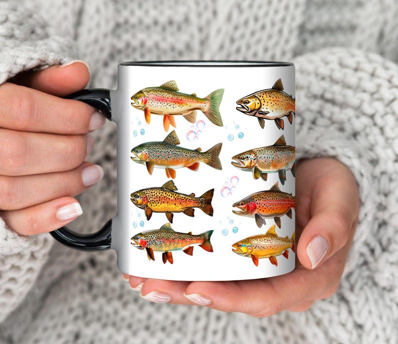 May include: White ceramic mug with a black handle and rim, featuring colorful illustrations of various fish species. The fish are depicted in detail with vibrant colors and scales, set against a white background with blue bubbles.