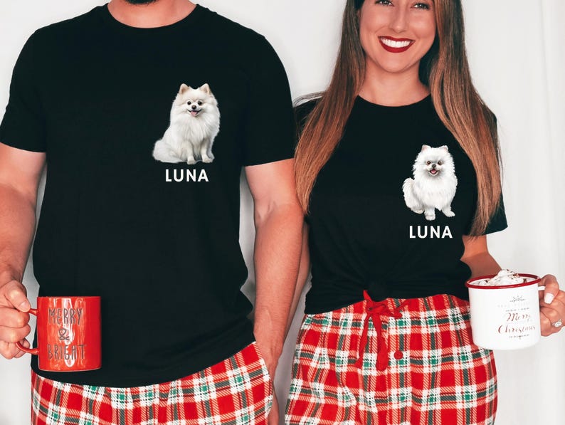 May include: Two people wearing black t-shirts with a white dog illustration and the name "Luna" printed on them. They are wearing red and green plaid pajama pants. The person on the left is holding a red mug with the text "Merry & Bright".