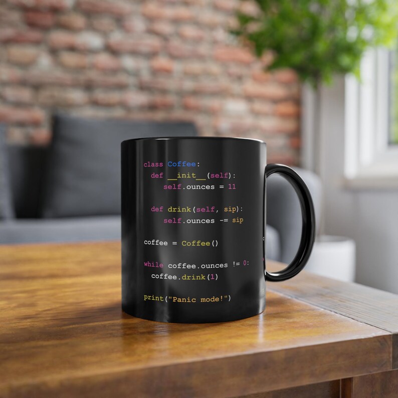 May include: Black coffee mug with a humorous code snippet printed on it. The code is written in Python and reads: "class Coffee: def __init__(self): self.ounces = 11 def drink(self, sip): self.ounces -= sip coffee = Coffee() while coffee.ounces != 0: coffee.drink(1) print('Panic mode!')"