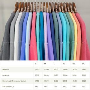 May include: Size chart for a variety of colors of sweatshirts. The chart shows the width, length, sleeve length, and size tolerance in inches for sizes S, M, L, XL, 2XL, and 3XL.