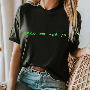May include: A black t-shirt with the text "sudo rm -rf / *" printed in green.