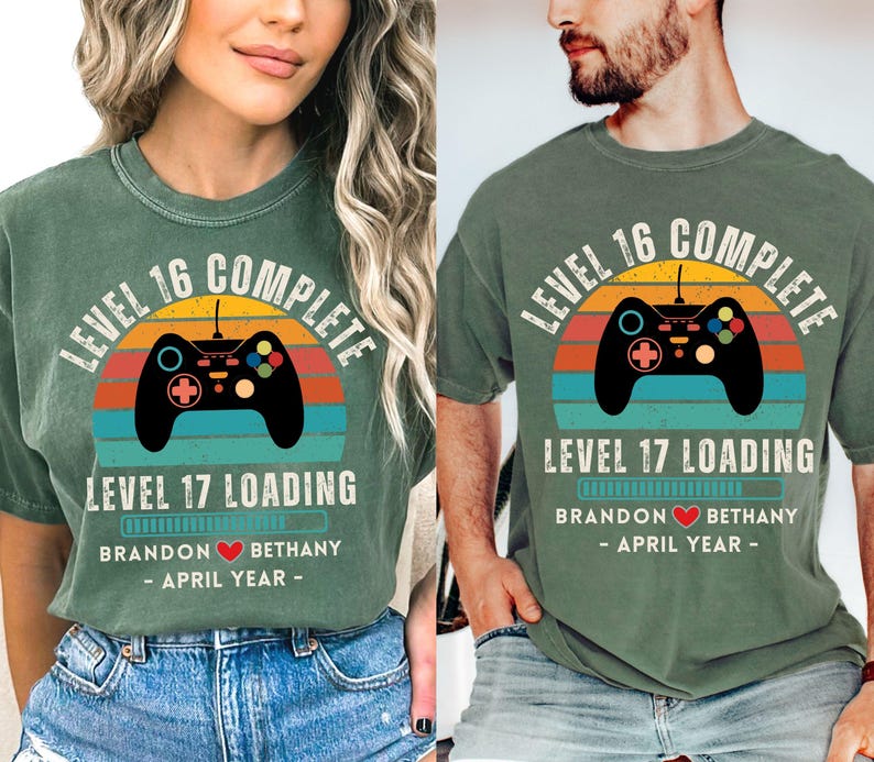 May include: A pair of green t-shirts with a retro video game controller graphic and the text "Level 16 Complete" and "Level 17 Loading". The shirts also include the text "Brandon Bethany - April Year -"