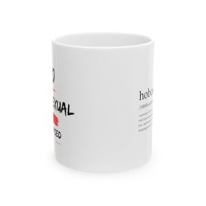 May include: White ceramic mug with black text that reads "I'm not sexual, I'm used". The word "sexual" is crossed out in red. The mug also has the definition of the word "hobo" printed on it.