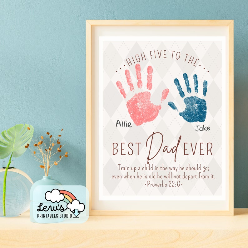 May include: A printable Father's Day sign with a grey and white diamond pattern background. Two handprints, one pink and one blue, are at the top of the sign. The text reads "...HIGH FIVE TO THE..." above the handprints and "BEST Dad EVER" below the handprints. The names "Allie" and "Jake" are written below the handprints. The text "Train up a child in the way he should go; even when he is old he will not depart from it. -Proverbs 22:6." is at the bottom of the sign.