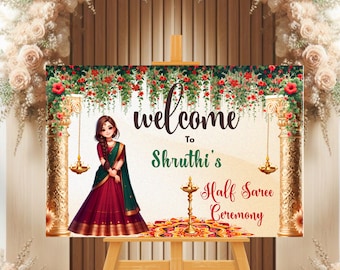 May include: Welcome to Shruthi's Half Saree Ceremony sign with a cartoon illustration of a girl in a red and green saree. The sign is decorated with flowers and gold accents.