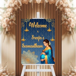 May include: Welcome to Sreeja's Seemantham sign with a blue background, gold accents, and a pregnant woman in a blue sari.
