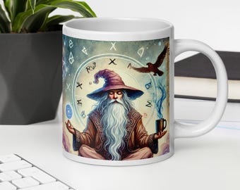 May include: White ceramic mug featuring a wizard with a long white beard and a purple hat. The wizard is in a meditative pose, surrounded by celestial symbols and a flying bird. The mug has a handle and is filled with a dark liquid.