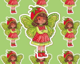 May include: A whimsical sticker of a strawberry fairy with green wings and a red strawberry hat. The fairy wears a red dress with white polka dots, red boots, and striped socks. The background is a light green colour with repeating fairy images.