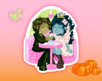 May include: A sticker illustration featuring two characters with curly hair sitting in a pink booth at a table with a milkshake. One character has olive skin and black clothing, the other has blue skin and a white dress. Text reads Angel Cookie.