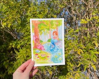 May include: A watercolour painting depicting two fairies seated by a pond. One fairy has pink wings and is reading a book. The other fairy has blue wings and is perched on a rock. The pond is surrounded by verdant trees and flowers.
