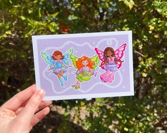 May include: A print featuring three fairies with colourful wings and dresses on a light purple background.