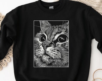 May include: Black sweatshirt with a white line drawing of a cat's face.