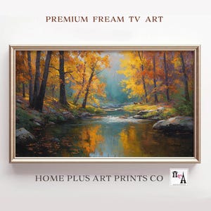 Könnte beinhalten: Gerahmtes Landschaftsgemälde, das eine ruhige Herbstszene zeigt. Goldene und orangefarbene Bäume säumen einen Fluss, der das Laub widerspiegelt. Das Kunstwerk trägt die Aufschrift "PREMIUM FREAM TV ART" und "HOME PLUS ART PRINTS CO."