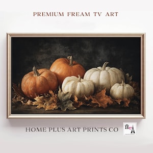 May include: A framed print featuring a still life of pumpkins and autumn leaves. The pumpkins vary in size and color, ranging from orange to white. The text "PREMIUM FREAM TV ART" and "HOME PLUS ART PRINTS CO" are visible.