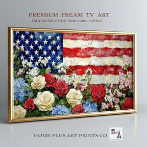 May include: A framed artwork featuring the American flag with a floral border. The flag's stars and stripes are rendered in textured paint, with red, white, and blue flowers at the base. The frame is gold, and the text "PREMIUM FREAM TV ART" is visible.