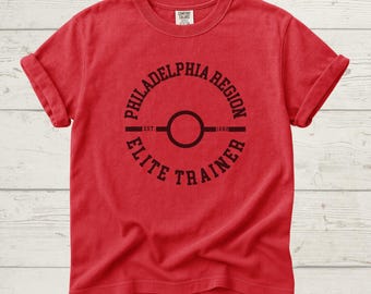 Camiseta de entrenador de élite de la región de Filadelfia, Poke, para fanáticos del anime y videojuegos, regalo para amantes del anime.