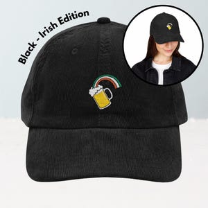 May include: Black corduroy baseball cap with an embroidered design of a beer mug and rainbow. The text "Black - Irish Edition" is printed on the side. The cap is shown in a studio setting.