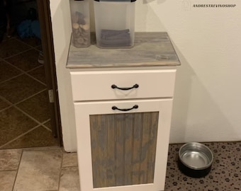 The garbage can cabinet.