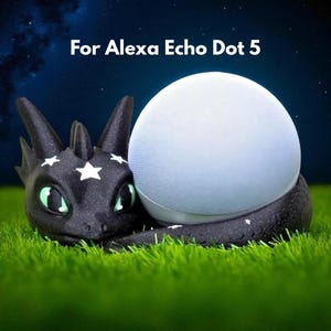 May include: A black dragon-shaped accessory with white star accents cradles a white Alexa Echo Dot 5 speaker. The text "For Alexa Echo Dot 5" is displayed above the speaker. The scene is set on green grass against a starry night sky.