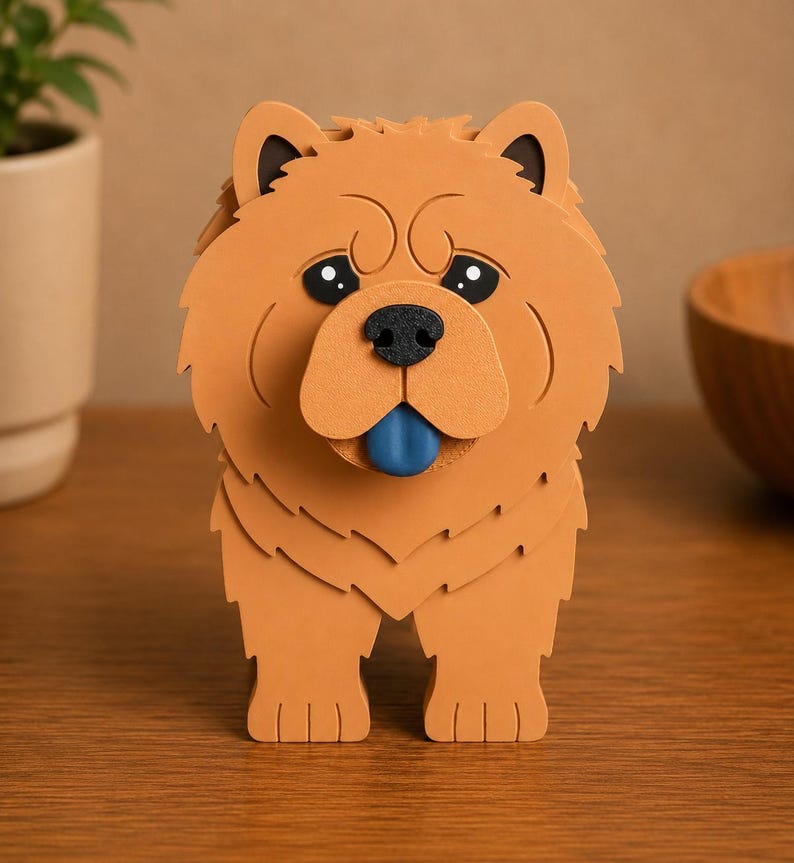May include: A brown Chow Chow dog figurine with black ears, a black nose, and a blue tongue. The dog has a layered design and is standing on a wooden surface. The figurine is a decorative item.