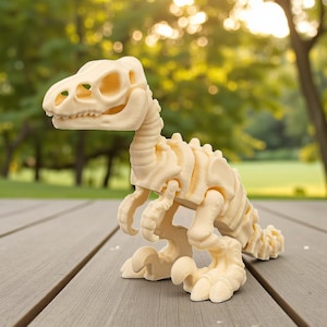 May include: A cream-colored dinosaur skeleton model with articulated joints. The model is made of a light-colored material and is posed on a wooden surface. The dinosaur has a detailed skull, spine, and limbs, and is a decorative item.