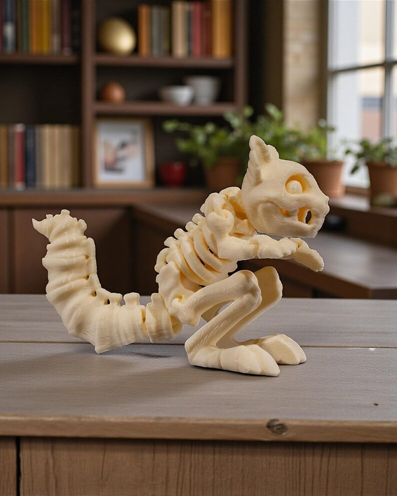 May include: A cream-colored squirrel skeleton figurine. The sculpture features detailed bone structure, including a long, curved tail and articulated limbs. The squirrel is posed in a seated position, with its front paws resting on a surface.