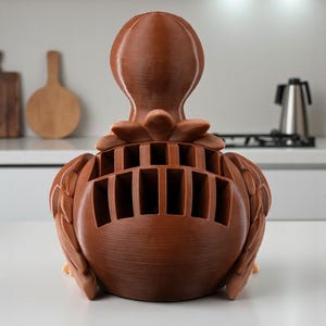 Puede incluir: Un bloque de cuchillos decorativo marr&oacute;n con forma de p&aacute;jaro. El bloque de cuchillos tiene m&uacute;ltiples ranuras para guardar cuchillos y est&aacute; hecho de un material s&oacute;lido y texturizado. Un accesorio de cocina &uacute;nico y funcional.