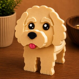 May include: A light tan, three-dimensional dog figurine with a black nose, large black eyes, and a pink tongue. The dog has a fluffy appearance and is standing on four blocky legs. The background is a warm brown.